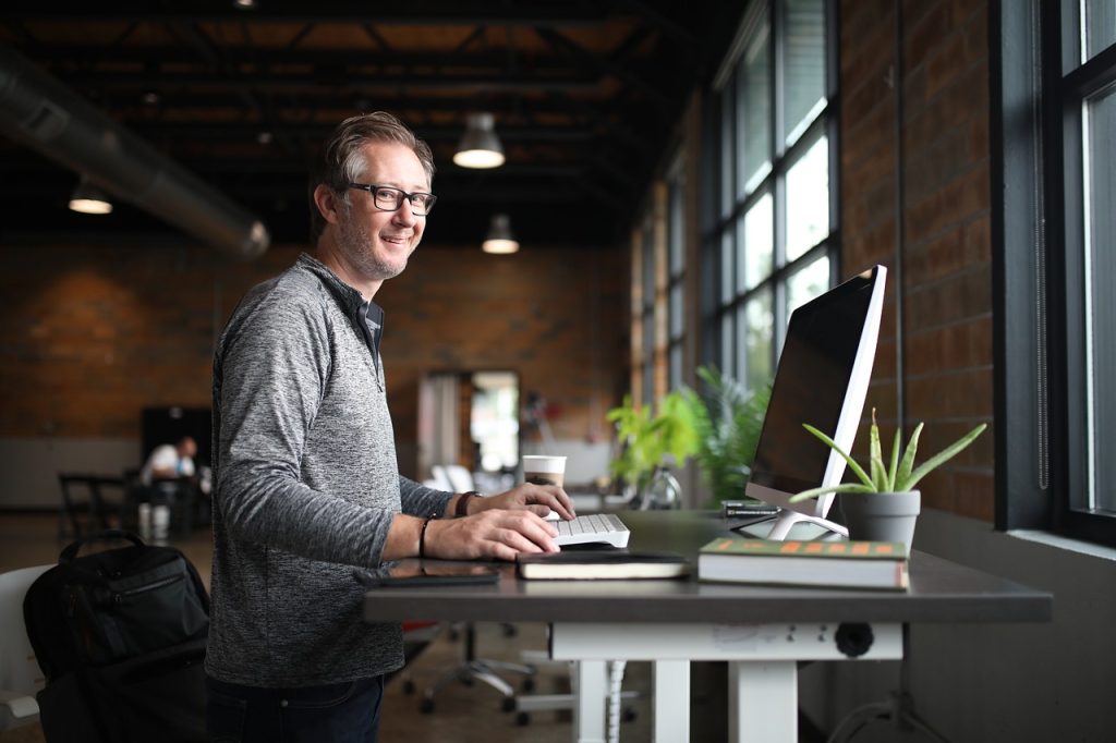 man using standing desk